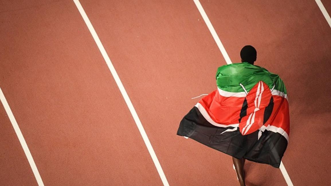 	Kenya's Agnes Jebet Tirop celebrates with the national flag after finishing third in the Women's 10,000m final at the 2019 IAAF World Athletics Championships at the Khalifa International stadium in Doha on September 28, 2019. (Photo by Antonin THUILLIER / AFP) (Photo by ANTONIN THUILLIER/AFP via Getty Images