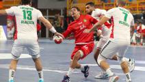 Morocco's centre back Harchaoui Amine (C) is challenged by Algeria's left back Hichem Daoud (R) and Algeria's wing Riad Chehbour (L) during the 2021 World Men's Handball Championship between Group F teams Algeria and Morocco at the New Capital Sports Hall in the Egyptian capital Cairo on January 14, 2021. (Photo by Khaled ELFIQI / POOL / AFP) (Photo by KHALED ELFIQI/POOL/AFP via Getty Images)