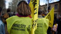 نشطاء بمنظمة العفو الدولية (آلان بيتون/ نورفوتو/ Getty)