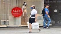  BRITAIN-HEALTH-VIRUS-RETAIL A shopper wears a mask as a precaution against the transmission of the novel coronavirus as he walks past a shop window on Oxford Street in London on July 14, 2020. - Face masks will be compulsory in shops and supermarkets in England from next week, the government said on July 14, in a U-turn on previous policy. (Photo by JUSTIN TALLIS / AFP) (Photo by JUSTIN TALLIS/AFP via Getty Images)
