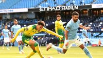 MANCHESTER, ENGLAND - JULY 26: Jamal Lewis of Norwich City and Riyad Mahrez of Manchester City battle for the ball during the Premier League match between Manchester City and Norwich City at Etihad Stadium on July 26, 2020 in Manchester, England.Football Stadiums around Europe remain empty due to the Coronavirus Pandemic as Government social distancing laws prohibit fans inside venues resulting in all fixtures being played behind closed doors. (Photo by Peter Powell/Pool via Getty Images)