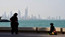 KUWAIT-SCENE-KUWAIT CITY A general view taken on December 26, 2017 shows a woman and child in front of a view of Kuwait City. / AFP PHOTO / GIUSEPPE CACACE (Photo credit should read GIUSEPPE CACACE/AFP via Getty Images)