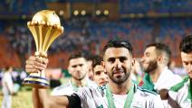 Algeria's Riyad Mahrez celebrates with the trophy during the award ceremony after Algeria defeated Senegal in the 2019 Africa Cup of Nations final soccer match at the Cairo International Stadium, in Cairo, Egypt, on 19 July 2019. (Photo by Islam Safwat/NurPhoto via Getty Images)