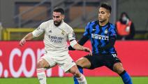 Real Madrid's Spanish defender Dani Carvajal (L) works around Inter Milan's Argentine forward Lautaro Martinez during the UEFA Champions League Group B football match Inter Milan vs Real Madrid on November 25, 2020 at the Giuseppe-Meazza (San Siro) stadium in Milan. (Photo by MIGUEL MEDINA / AFP) (Photo by MIGUEL MEDINA/AFP via Getty Images)