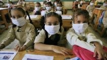 Egyptian school girls wear masks in class for protection against swine flu at a school in Cairo on October 4, 2009. Over 900 cases of the A(H1N1) flu have been reported in Egypt, and two people have died from it. Egypt, whose 80 million people make it the Arab world's most populous country, is already struggling with the deadly H5N1 strain of bird flu, and says it is not taking the swine flu lightly. AFP PHOTO/KHALED DESOUKI (Photo credit should read KHALED DESOUKI/AFP via Getty Images)