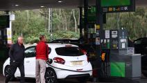 Motorists refuel their cars with petrol or diesel fuel at a petrol station off of the M3 motorway near Fleet, west of London on September 26, 2021. - Britain's transport secretary Grant Shapps on Sunday accused lorry industry representatives of helping to spark petrol panic-buying, as he defended a U-turn on post-Brexit immigration policy to ease an escalating supply crisis. (Photo by Adrian DENNIS / AFP) (Photo by ADRIAN DENNIS/AFP via Getty Images)