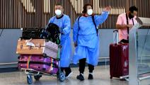 International travellers wearing personal protective equipment (PPE) arrive at Melbourne's Tullamarine Airport on November 29, 2021 as Australia records it's first cases of the Omicron variant of Covid-19. (Photo by William WEST / AFP) (Photo by WILLIAM WEST/AFP via Getty Images)