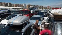 Passengers walk through cars waiting to embark on ferries bound for Tangier at the Algeciras port on July 27, 2019. - Thousands of Moroccan nationals working and living in Europe pass through the Strait of Gibraltar as they return to spend summer holidays in Morocco. (Photo by JORGE GUERRERO / AFP) (Photo credit should read JORGE GUERRERO/AFP via Getty Images)