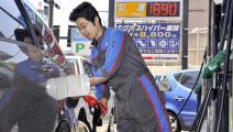 A gas station attendant fills up a customer's fuel tank at a Tokyo gas station on April 1, 2008 as the station cut petrol prices by 25 yen (25 US cents) a litre following the expiration of a special petrol tax. Motorists and gas station managers welcomed cheaper prices but were angry at the political deadlock over the expiration of the tax, for which Prime Minister Yasuo Fukuda apologised a day before. AFP PHOTO / Yoshikazu TSUNO (Photo credit should read YOSHIKAZU TSUNO/AFP/Getty Images)