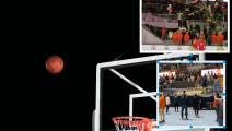 Basketball in air moving towards hoop, low angle view - stock photo