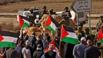 الأعلام الفلسطينية أثناء مظاهرة في مدينة نابلس (زين جعفر/فرنس برس)