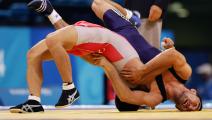ATHENS - AUGUST 26: Makoto Sasamoto of Japan (red) wrestles Nurlan Koizhaiganov of Kazakhstan in the men's Greco-Roman wrestling 60 kg final classification round on August 26, 2004 during the Athens 2004 Summer Olympic Games at Ano Liossia Olympic Hall in Athens, Greece. (Photo by Doug Pensinger/Getty Images)