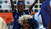 A Sudanese boy and his father cheer for al-Hilal during their African Champions League football match against Zambia's Zesco United in Khartoum late on July 31, 2009. Hilal won 1-0. AFP PHOTO/ASHRAF SHAZLY (Photo credit should read ASHRAF SHAZLY/AFP via Getty Images)	