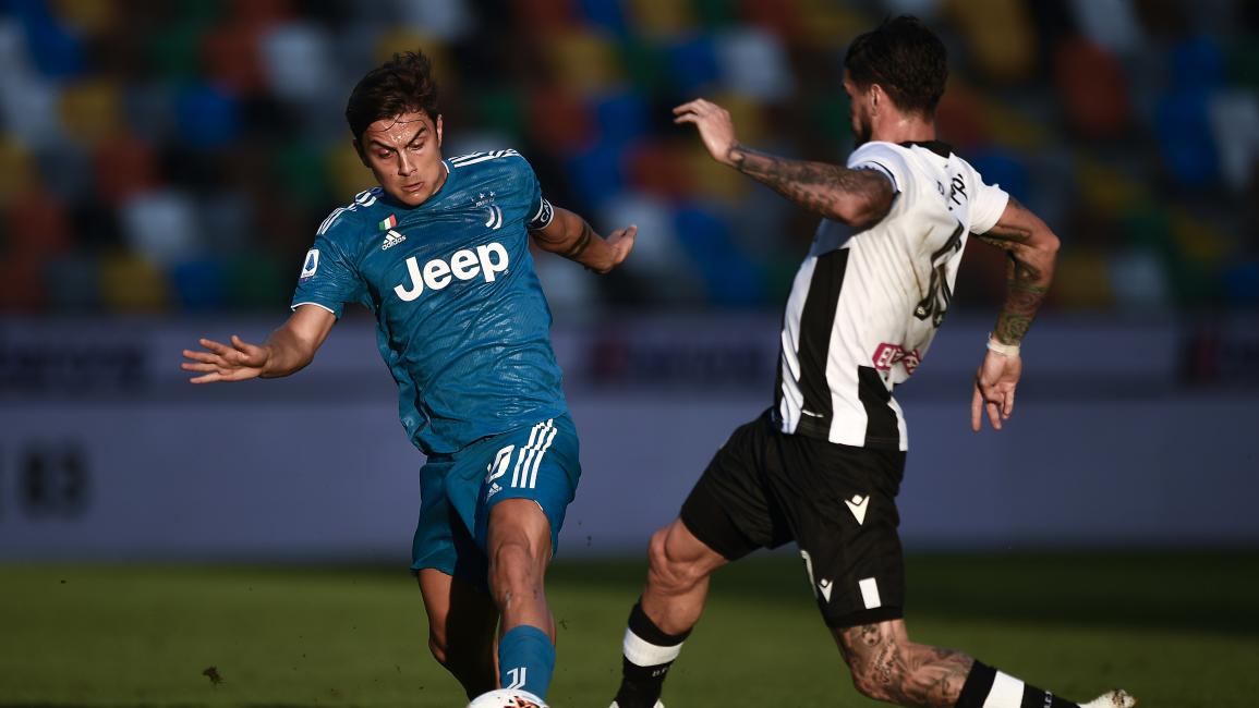 Paulo Dybala (L) of Juventus FC is challenged by Rodrigo de...