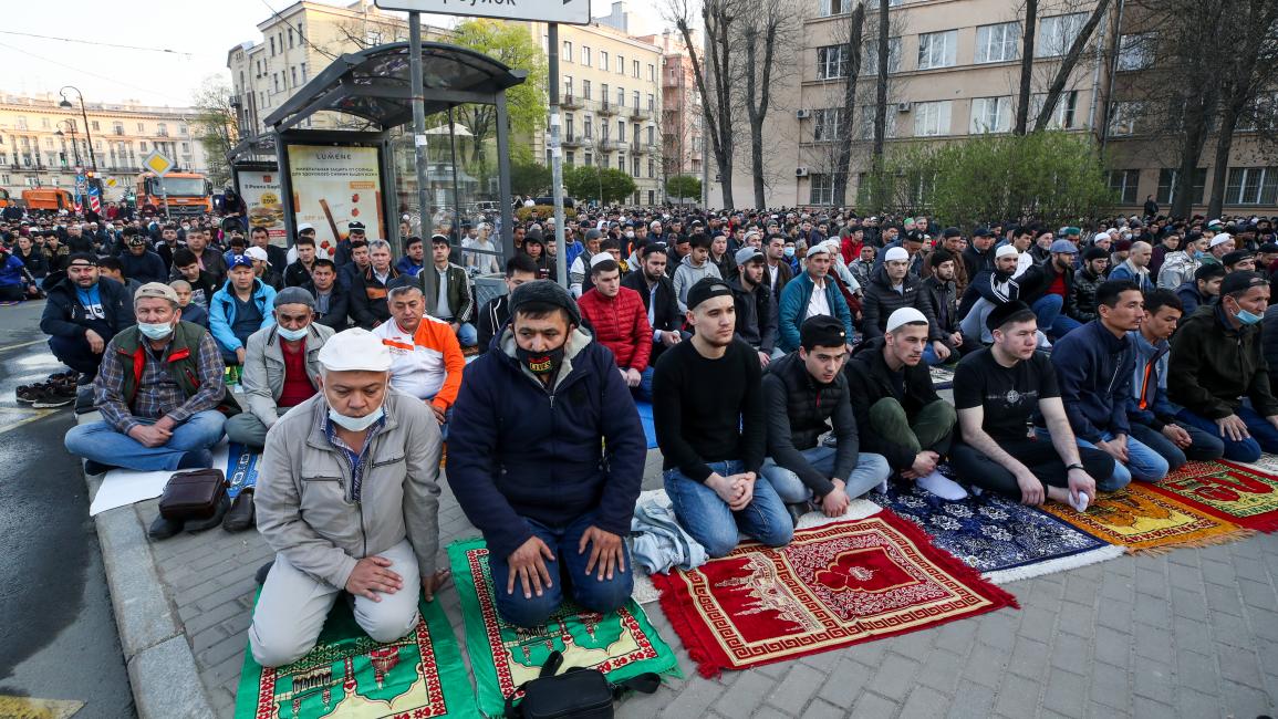 مسلمون يؤدون صلاة عيد الفطر خارج مسجد سانت بطرسبرغ في روسيا، اليوم الخميس (ألكسندر ديميانتشوك/تاسّ)