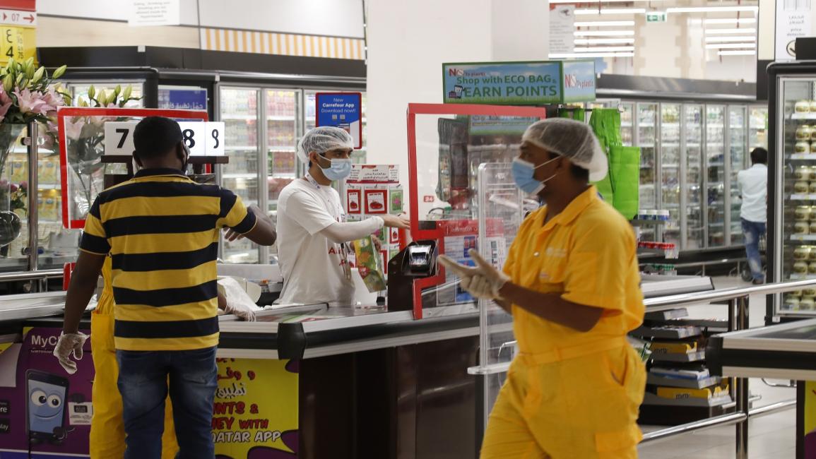 QATAR-HEALTH-VIRUS Employees work while wearing protective mask and gloves at a supermarket in the Mall of Qatar following its reopening in the capital Doha on June 15, 2020, as the country gradually lifts its Covid-19 lockdown. (Photo by KARIM JAAFAR / AFP) (Photo by KARIM JAAFAR/AFP via Getty Images)