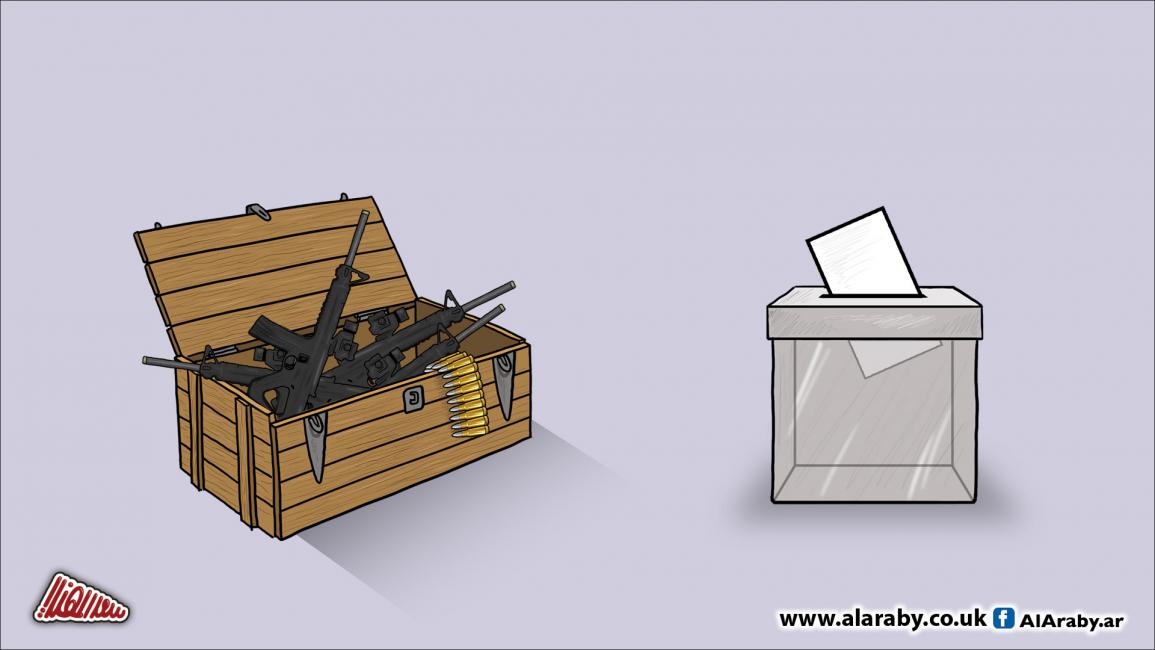 مقالات كاريكاتير صندوق انتخابات وصندوق سلاح