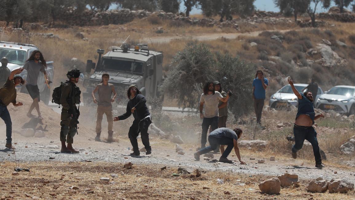 مستوطنون يرشقون الفلسطينيين بالحجارة تحت حماية جيش الاحتلال (عصام الريماوي/ الأناضول)