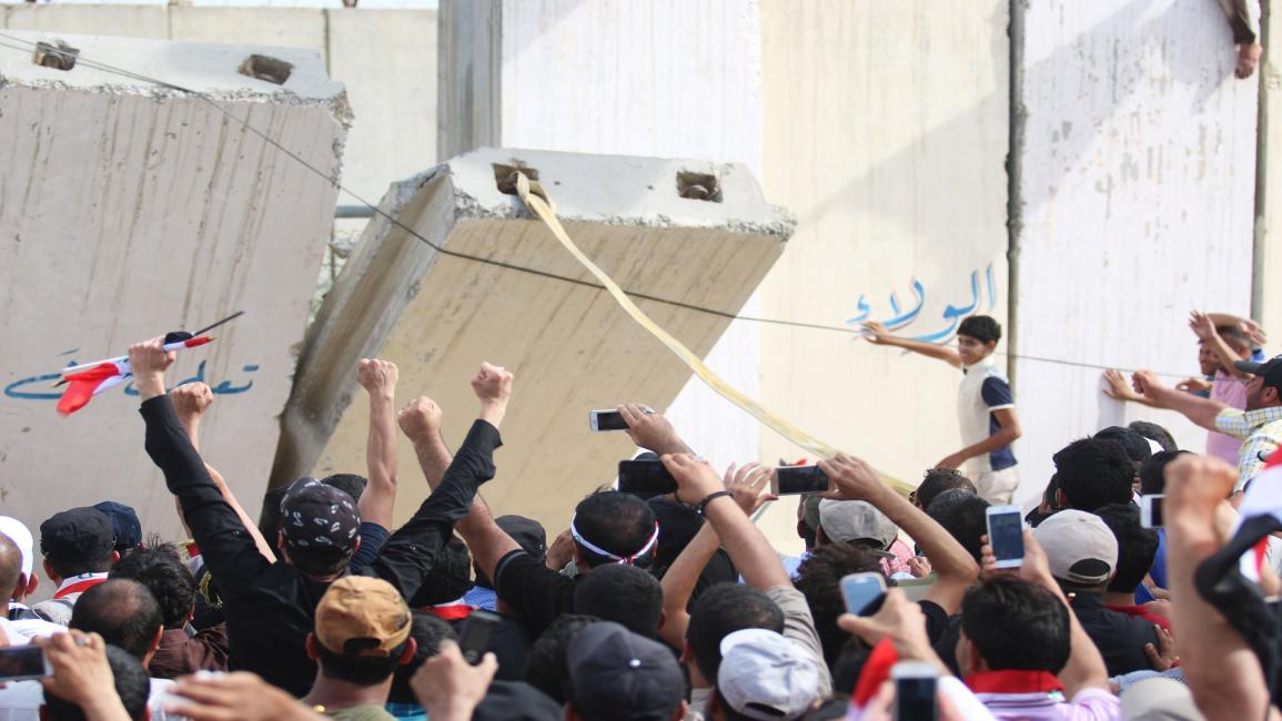 محتجون عراقيون يسقطون جدار حول البرلمان
