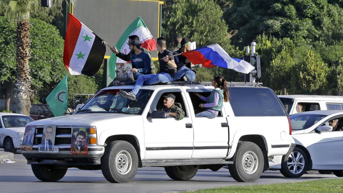 أعلام سورية روسيا إيران في دمشق- فرانس برس