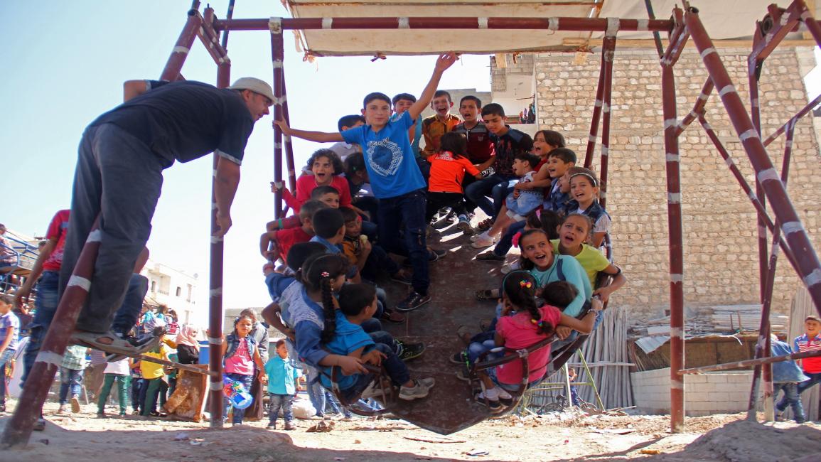 أطفال سوريون يتأرجحون- فرانس برس