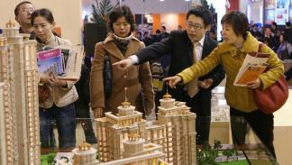 Shanghai, CHINA: Chinese investors talk with a property salesman for a new housing development at a real estate exhibition in Shanghai, 16 March 2007. China's parliament overwhelmingly approved a property law that has sparked controversy by offering unprecedented protection to the private sector. The legislation had been through a record 13 years of debate, passed seven readings and been the subject of criticism and proposals from 47 government departments and an unprecedented 11,500 members of the public. 
