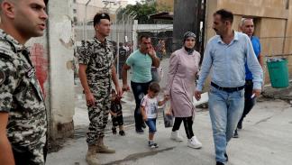 لاجئون سوريون وقوات أمن لبنانية في منطقة برج حمود (أنور عمرو/ فرانس برس)