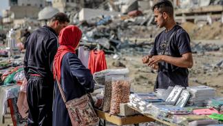 بائع يعرض البزورات وسط الدمار في مدينة غزة/ فرانس برس