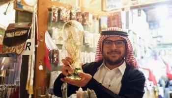 DOHA, QATAR - JANUARY 03: A merchant holds up a plastic copy of the FIFA World Cup at Souq Waqif during the FC Bayern Muenchen training camp on January 3, 2018 in Doha, Qatar. (Photo by Alex Grimm/Bongarts/Getty Images)
