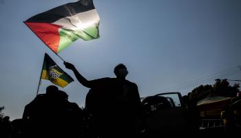 شخص يلوح بعلم فلسطين خلال اعتصام مؤيد للفلسطينيين أمام السفارة الإسرائيلية في جنوب أفريقيا في 25 /5 /2021 (Getty)
