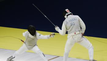 DOHA, QATAR - DECEMBER 09: Ali Faraj (R) of Iraq in action against Javad Rezaei Tadi (L) of the Islamic Republic of Iran during the Men's Individual Foil Fencing competition during the 15th Asian Games Doha 2006 at the Al-Arabi Sports Club on December 9, 2006 in Doha, Qatar. (Photo by Streeter Lecka/Getty Images for DAGOC)