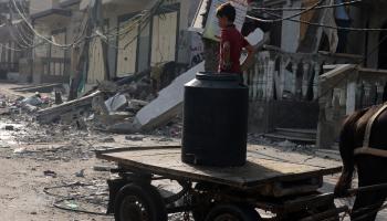 طفل ومياه ودمار في قطاع غزة (محمد عابد/ فرانس برس)