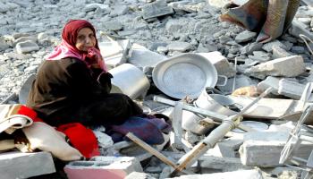 فلسطينية تجلس على أنقاض منزلها المدمر في رفح، جنوب قطاع غزة، في 14/10/2023 (فرانس برس)