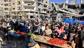 سوق بين مبانٍ دمرها قصف إسرائيلي في مخيم النصيرات وسط قطاع غزّة في 30/ 11/ 2023 (الأناضول)