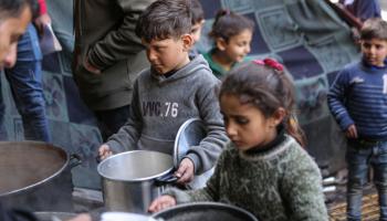 أطفال فلسطينيون في شمال غزة ينتظرون حصة الطعام (داود أبو الكاس/ الأناضول)