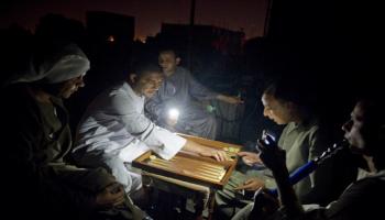 مصريون يلعبون النرد أثناء انقطاع الكهرباء