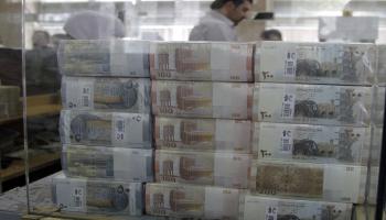 syria money/ louai bechara/afp
