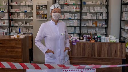 A Pharmacist is seen with precautions against the Coronavirus outbreak in Istanbul, Turkey, on April 27, 2020. Citizens can apply for free face masks through the country's postal services' e-commerce website, and get their masks from pharmacies. Pharmacists have been working under difficult circumstances since the beginning of the outbreak, and most pharmacies serve citizens through the doors without letting people in to practice social distancing. The health minister reported that total number of confirmed