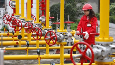 An employee of China Petroleum conducts routine checks at a gas refinery in Suining, Sichuan province November 19, 2009. Piped-gas supplier China Gas Holdings said on Wednesday that PetroChina is in talks to invest in a China Gas unit, which will distribute liquefied petroleum gas (LPG) for Asia's top oil producer. VCP (Photo by Jie Zhao/Corbis via Getty Images)